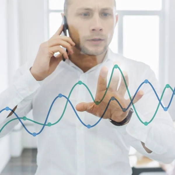 businessman-doing-phone-call-looking-charts