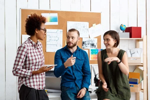 colleagues-smiling-speaking-discussing-new-ideas-office